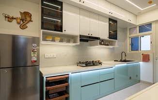 Modern modular kitchen interior design in Hyderabad with blue cabinets and compact layout