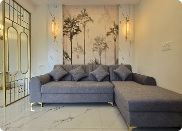 Modern living room interior design in Hyderabad with grey sofa and decorative wall design